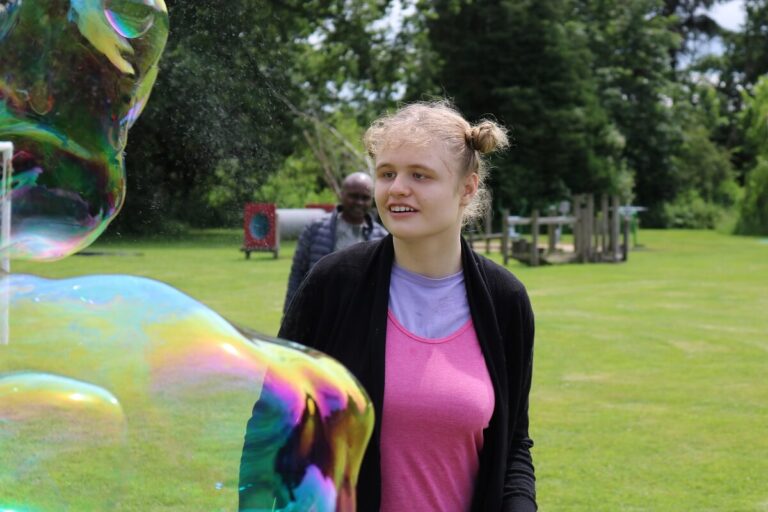 girl looking at bubbles