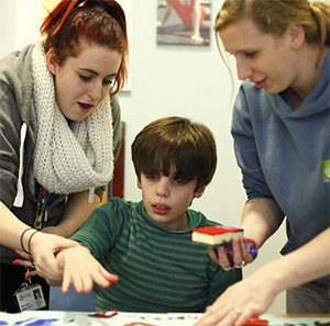 boy hand painting with two woman