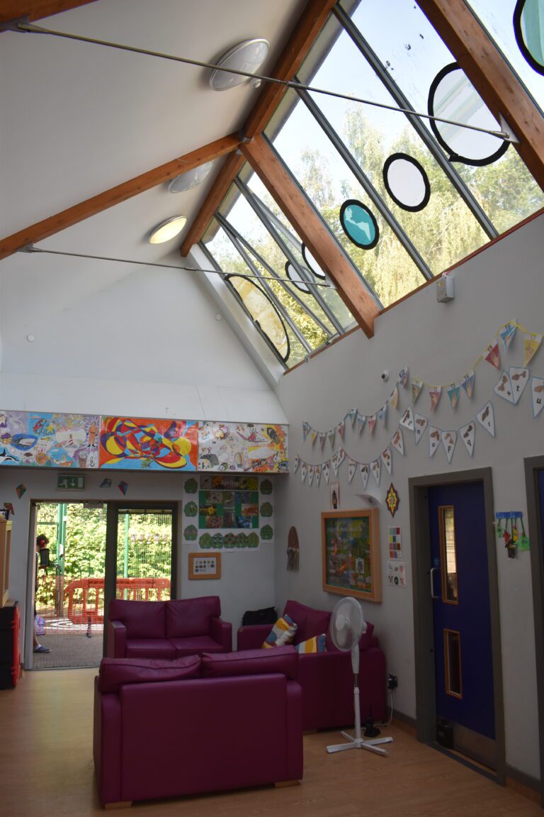 inside of a room with flags on wall and sofas