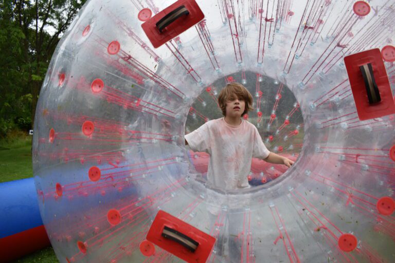 boy inside of a massive inflatable ball