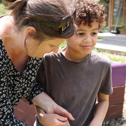 woman holding a happy boys hand