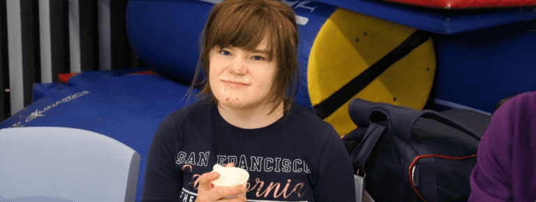 girl eating ice-cream with it sticking onto their face