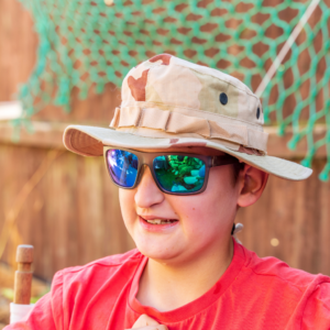 boy wearing sunglasses and a hat