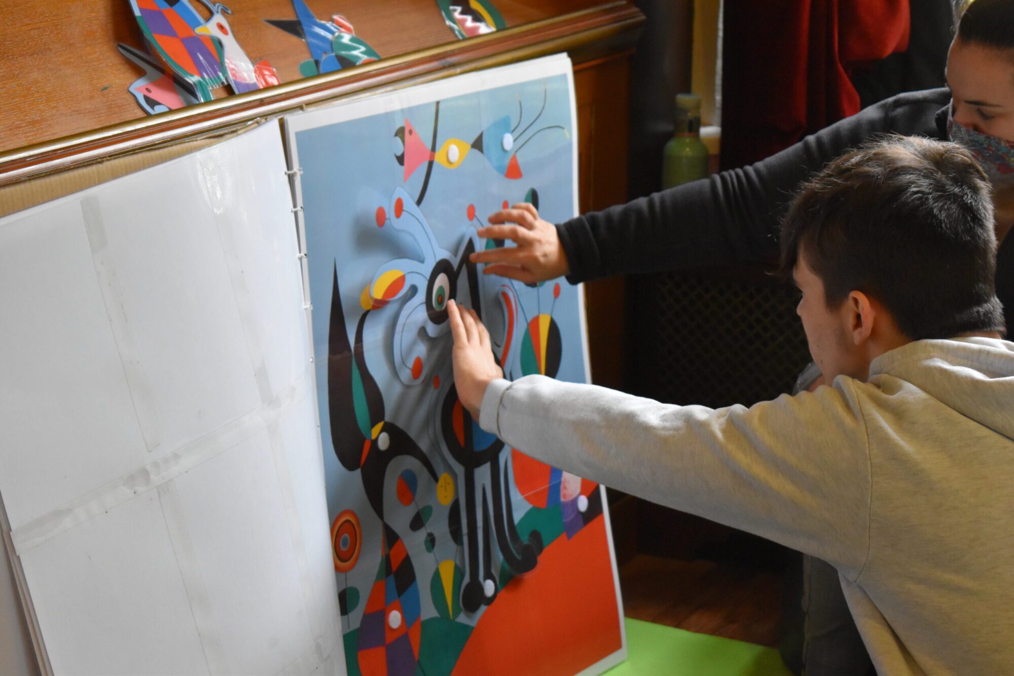 boy touching large image